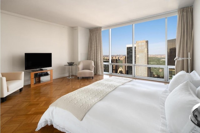 bedroom with expansive windows and parquet floors