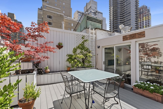 wooden deck featuring outdoor dining area