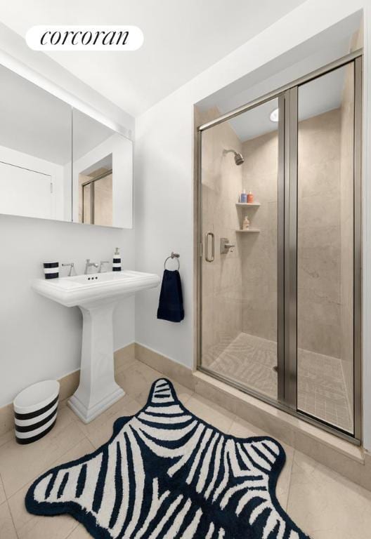 bathroom featuring tile patterned flooring and a shower with door