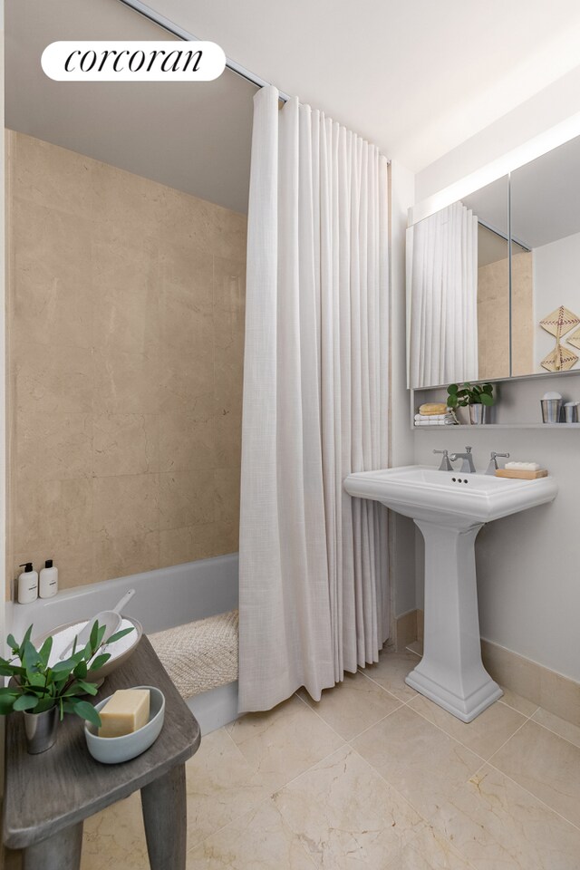 bathroom with a shower with shower door and tile patterned floors