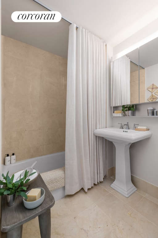 bathroom with tile patterned floors and shower / bath combo