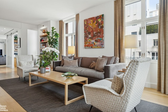 living room with a wealth of natural light and light hardwood / wood-style floors