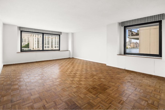 unfurnished room featuring dark parquet flooring