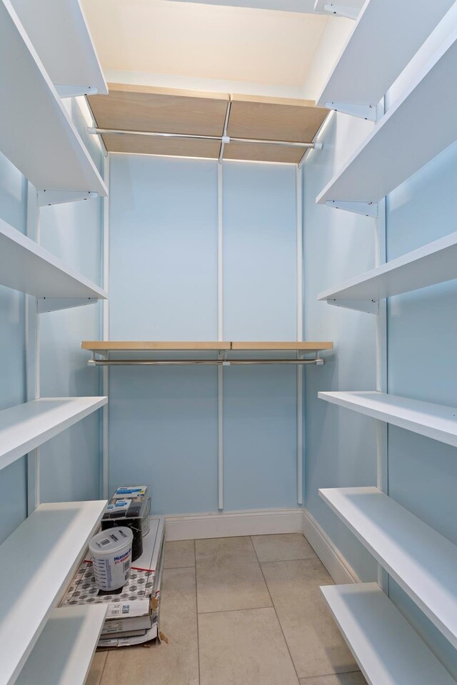 spacious closet featuring light tile patterned floors