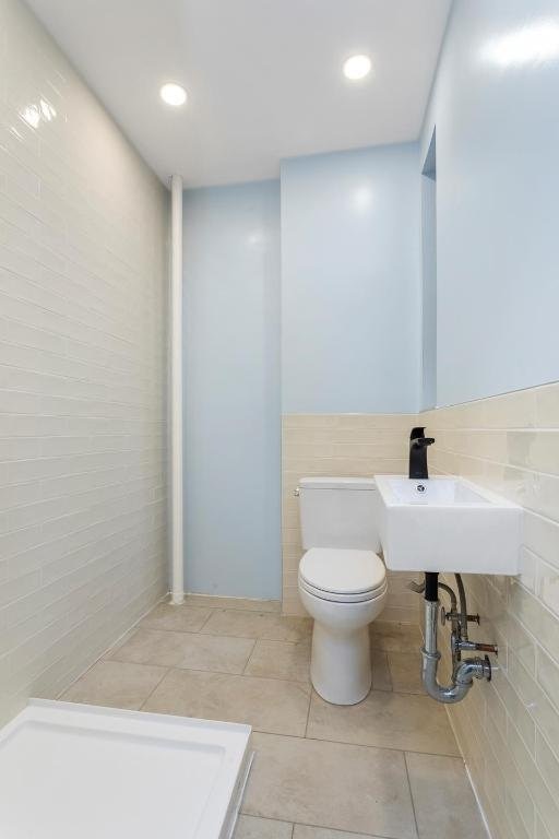 bathroom with toilet and tile patterned floors