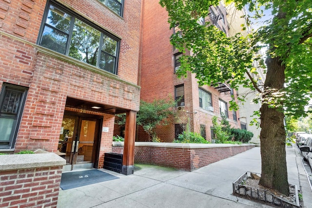 doorway to property with brick siding