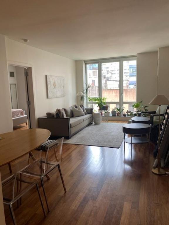 living room with expansive windows and hardwood / wood-style flooring