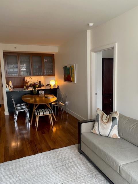 dining area featuring dark wood-style floors and baseboards