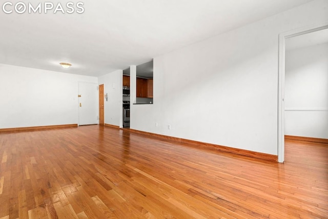 spare room featuring light hardwood / wood-style flooring