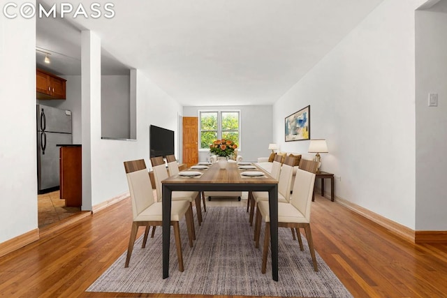 dining space with light wood-type flooring