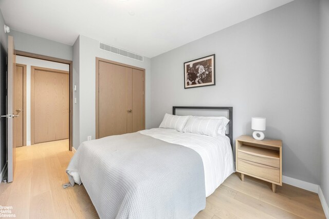 bedroom with a closet and light hardwood / wood-style flooring