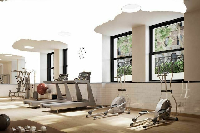 workout area with hardwood / wood-style floors