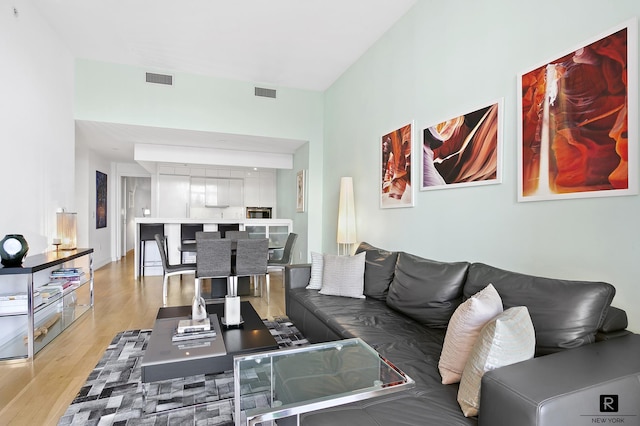 living area with light wood finished floors and visible vents