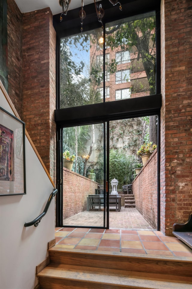 178 E 75th St, New York City, NY 10021 - stairs with a high ceiling, plenty of natural light, and brick wall
