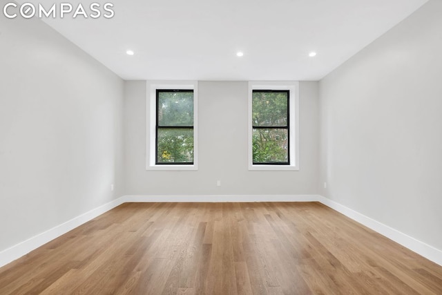 empty room with light hardwood / wood-style flooring