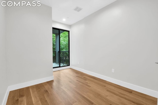 spare room featuring hardwood / wood-style floors