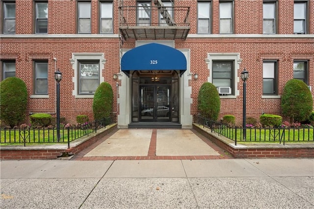 doorway to property with brick siding