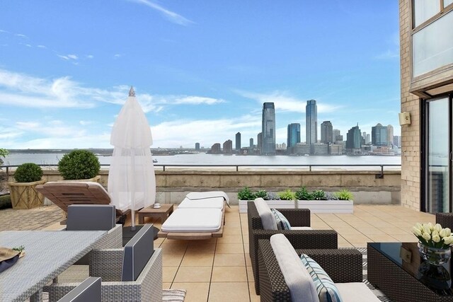 view of patio / terrace featuring outdoor lounge area and a water view