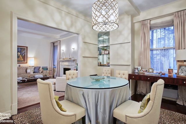 dining space featuring wood-type flooring, a notable chandelier, and beamed ceiling