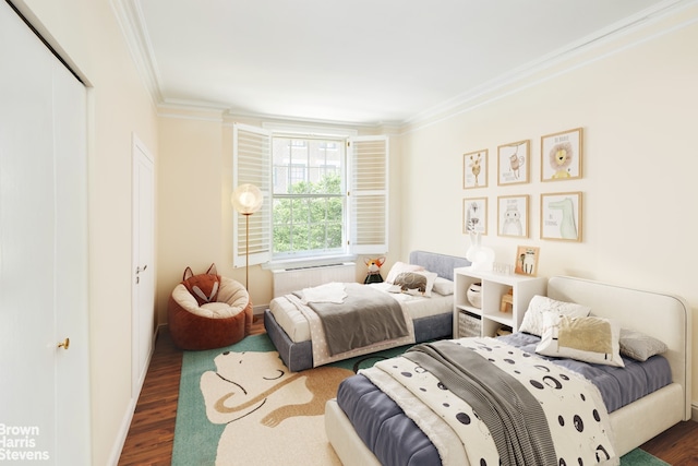 bedroom featuring crown molding, wood finished floors, radiator, a closet, and baseboards