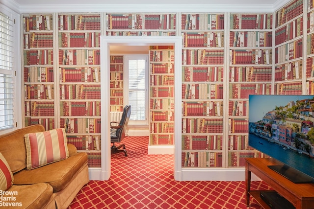 living area featuring crown molding