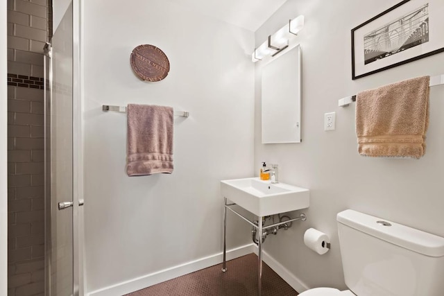 bathroom featuring an enclosed shower and toilet