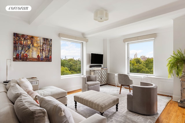 living room with beam ceiling and hardwood / wood-style flooring