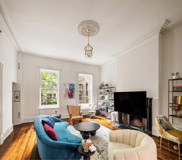 living room with crown molding and hardwood / wood-style flooring