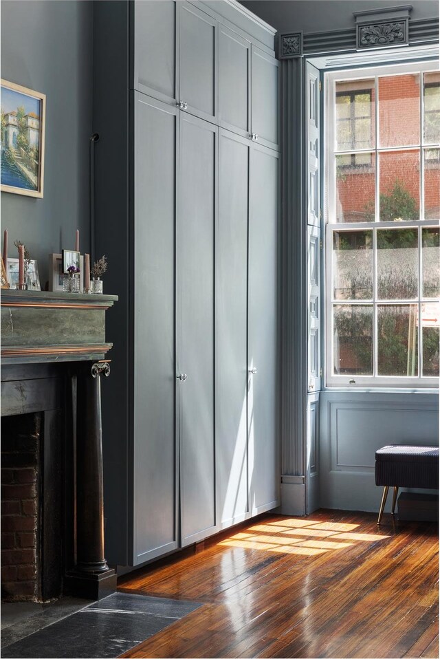 doorway with a fireplace and wood-type flooring