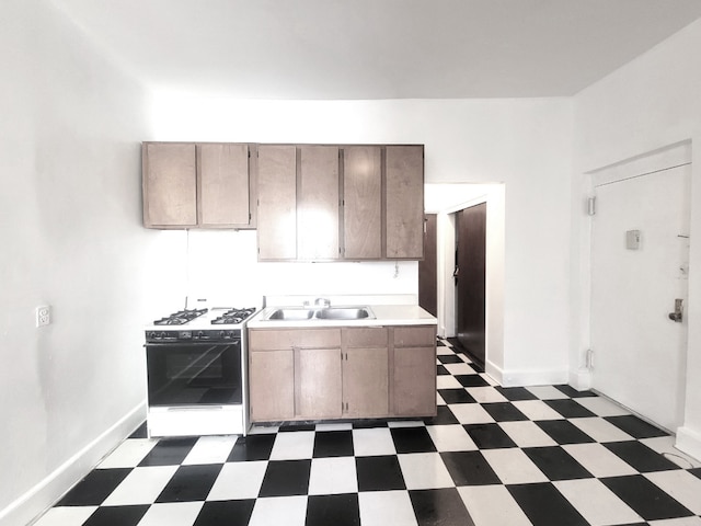 kitchen featuring sink and white gas range oven