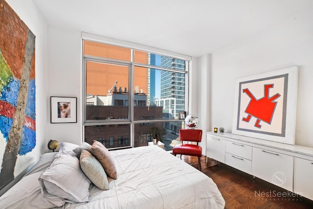 bedroom featuring dark hardwood / wood-style floors and a wall of windows