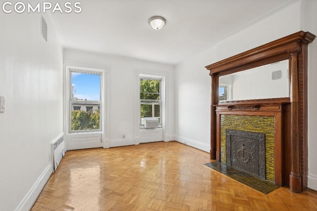 unfurnished living room with cooling unit and light parquet floors