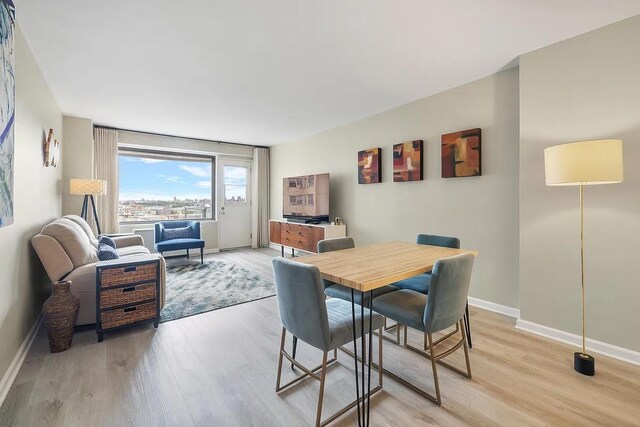 1020 Grand Concourse Unit 15V, New York City, NY 10452 - dining space with baseboards and light wood finished floors