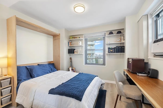 bedroom featuring baseboards and wood finished floors
