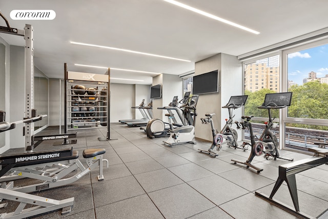 exercise room featuring floor to ceiling windows and visible vents