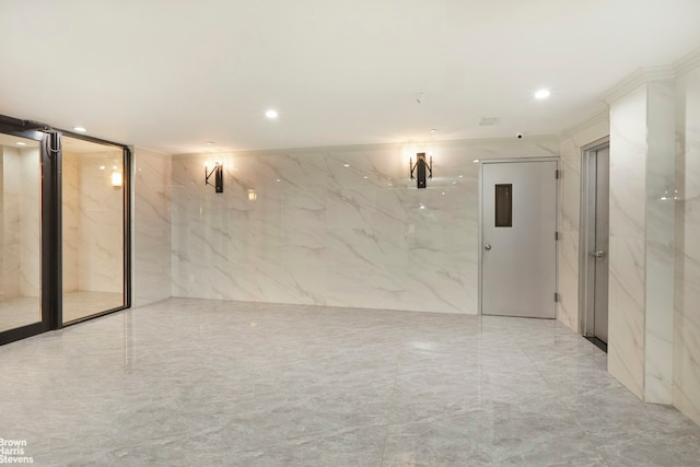 empty room with recessed lighting, tile walls, and marble finish floor