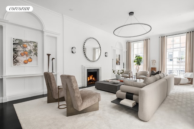 living room with crown molding and light hardwood / wood-style flooring