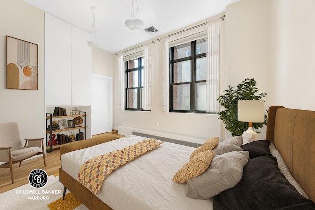 bedroom with hardwood / wood-style floors