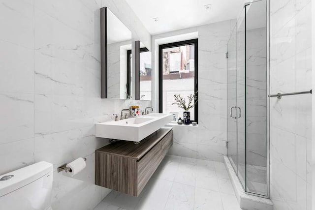 bathroom featuring toilet, tile walls, vanity, and walk in shower