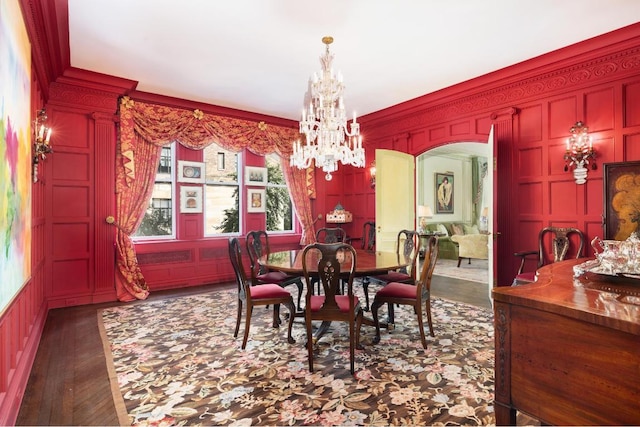 dining room with crown molding, dark hardwood / wood-style floors, and a notable chandelier