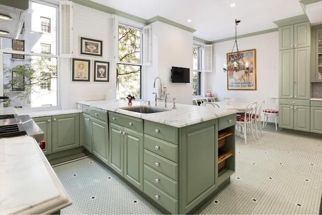 kitchen with sink, pendant lighting, green cabinets, and crown molding