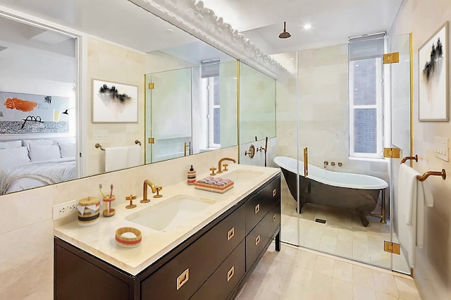 bathroom featuring plus walk in shower, tile walls, and vanity