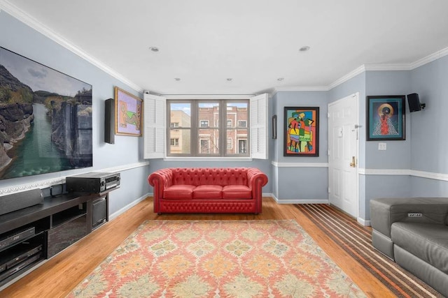 living room with hardwood / wood-style flooring and crown molding