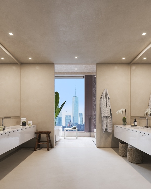 bathroom with a tub to relax in, vanity, and concrete floors