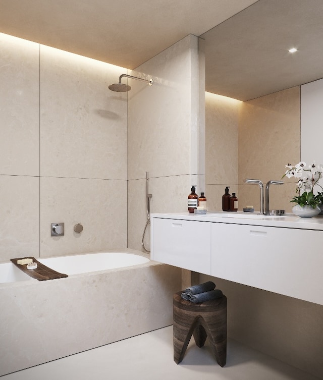 bathroom with vanity, tile walls, and shower / tub combination