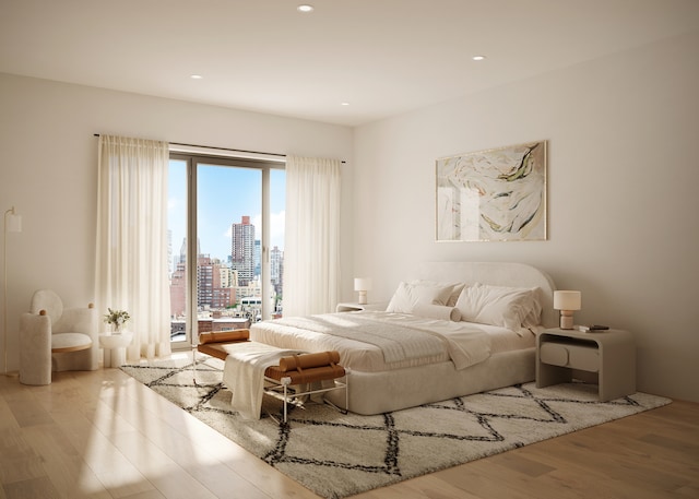 bedroom with access to exterior, light wood finished floors, recessed lighting, and a city view