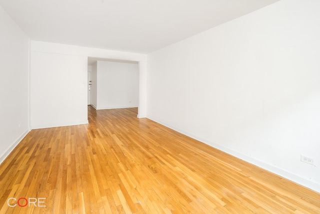 unfurnished room with light wood-type flooring