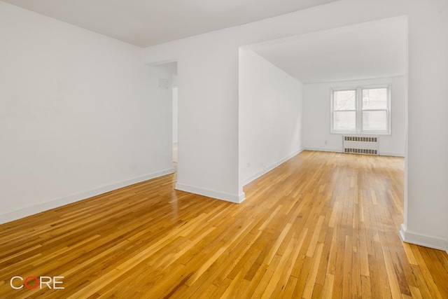 interior space with radiator and light hardwood / wood-style flooring