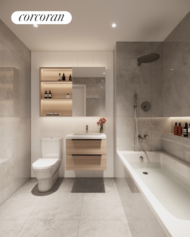 bathroom featuring vanity, tile walls, and toilet