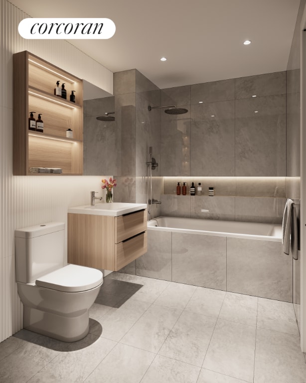 full bathroom with vanity, tiled shower / bath combo, and toilet